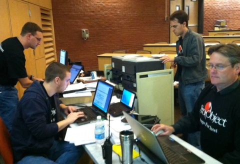 Employees checking computer results on laptops